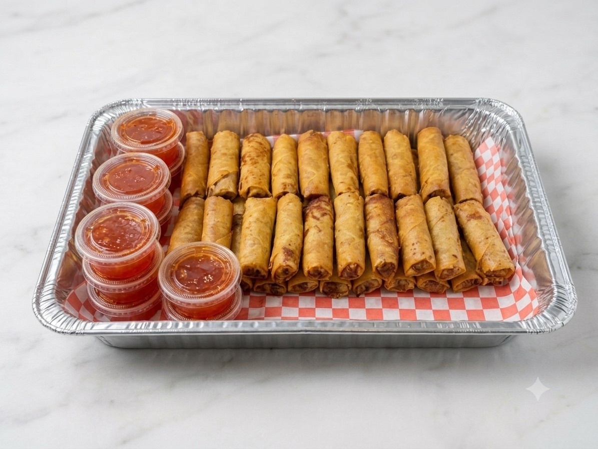 A Phở Rolls catering tray of fried egg rolls with sweet chili sauce cups